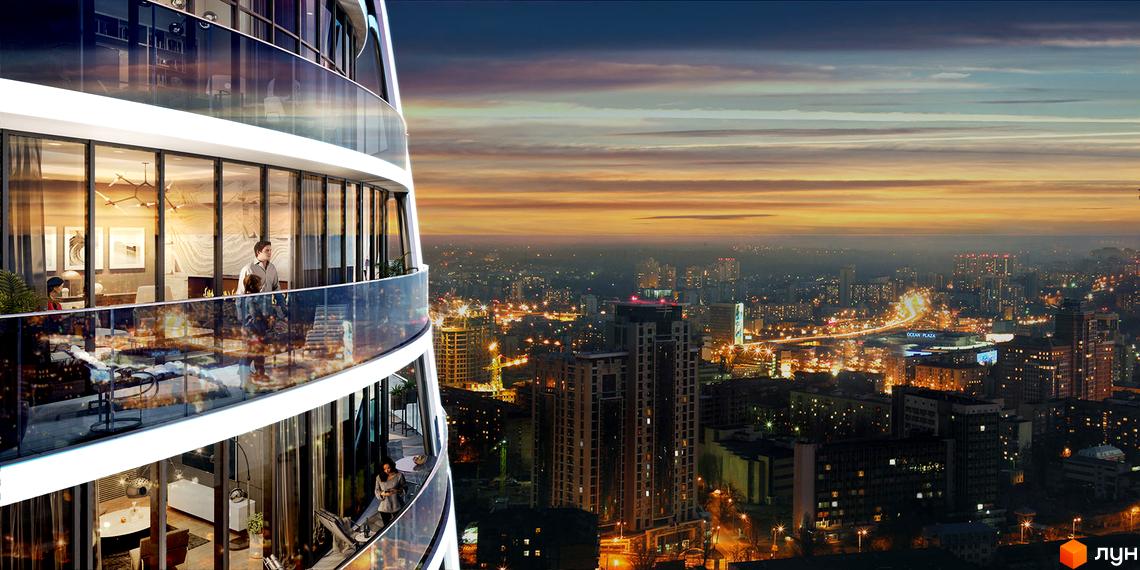 Taryan Towers - житловий комплекс з панорамними вікнами та балконами, що виходять на вечірнє місто. Сучасна архітектура та вид на місто.