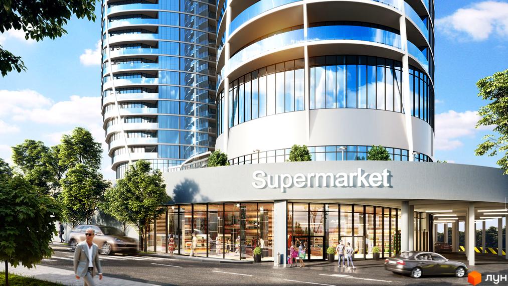 Taryan Towers - житловий комплекс з фасадами з блакитного скла та балконами, що оточують будівлю. На першому поверсі розташований супермаркет. Територія навколо комплексу озеленена деревами, поруч проїжджають автомобілі.