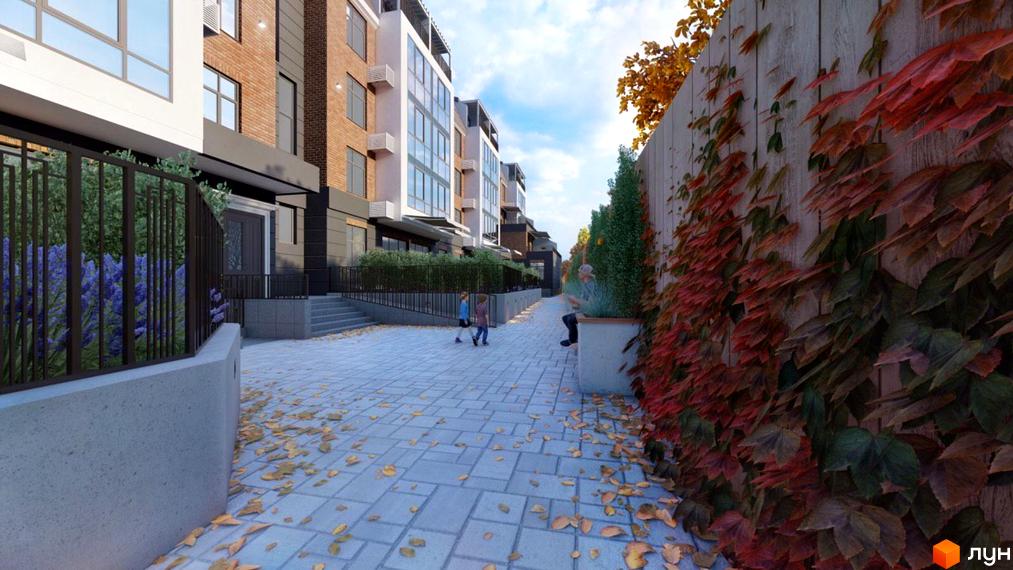 Житловий комплекс Comfort Hall: фасади будинків з цегли та скла, вимощена бруківкою алея, зелені насадження та осіннє листя.