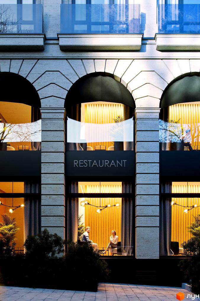 Клубний будинок „Воронцовський“ з фасадом з натурального каменю та великими вікнами, біля входу розташовані зелені насадження та літній майданчик.