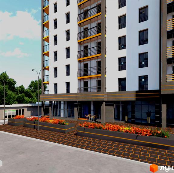 Зображення фасаду та прибудинкової території Житлового комплексу Концепт. Багатоповерхова будівля з балконами, квіткові клумби вздовж тротуару.