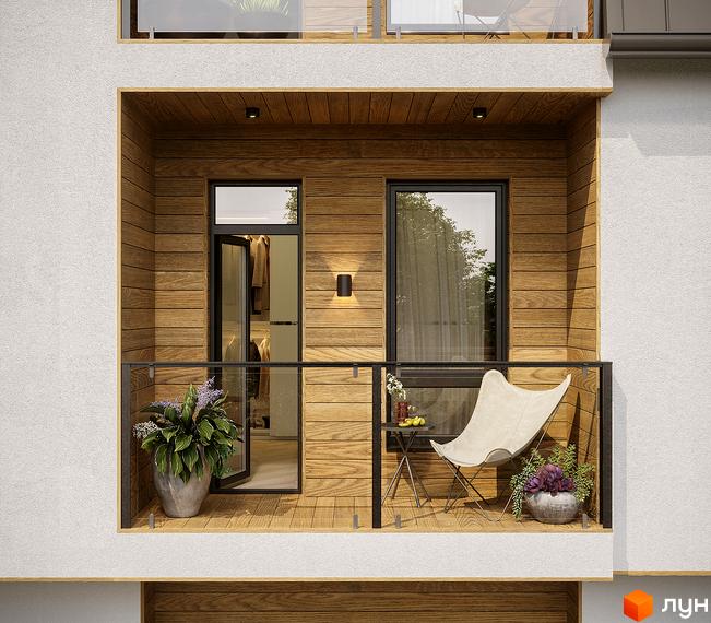 Балкон з дерев'яною обшивкою та скляними перилами на вул. Окружна, 74. На балконі розташовані крісло, столик та рослини.