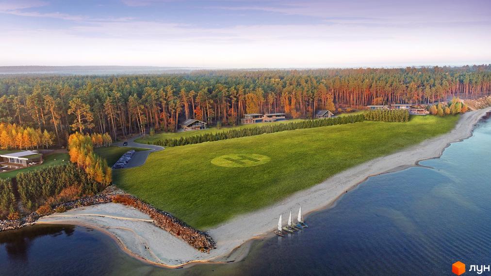 Котеджне містечко КМ New Haven Luxury Village з сучасними будинками на березі водойми, оточений лісом. Територія комплексу включає зелений газон з вертолітним майданчиком та пляж з вітрильниками.
