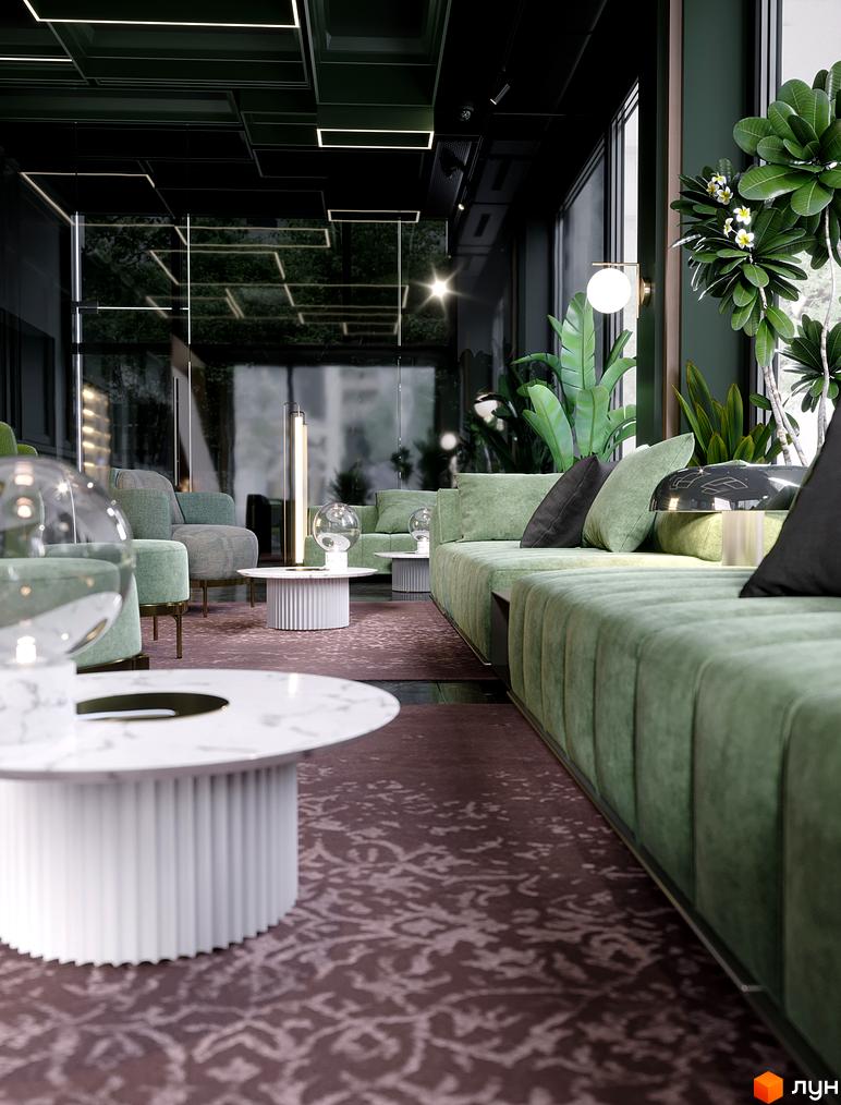 Інтер'єр вітальні в житловому комплексі GENEVE з зеленими диванами та кавовими столиками. Простір оформлений у сучасному стилі з акцентом на комфорт та елегантність.