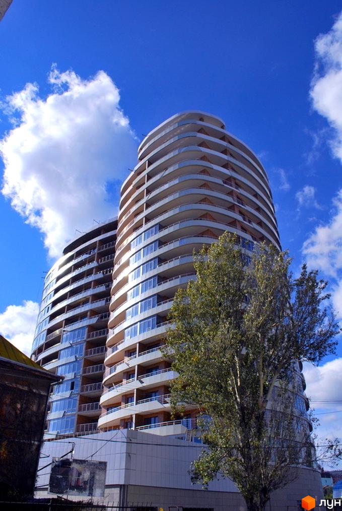 Житловий комплекс Ланжерон з сучасною архітектурою та великими панорамними вікнами. Прибудинкова територія озеленена деревами.