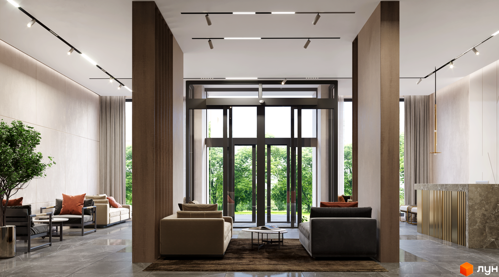 Лобі житлового комплексу Новий Автограф з диванами, столиками та великими вікнами, що виходять на зелену зону. Сучасний дизайн інтер'єру з акцентом на природні матеріали та комфорт.