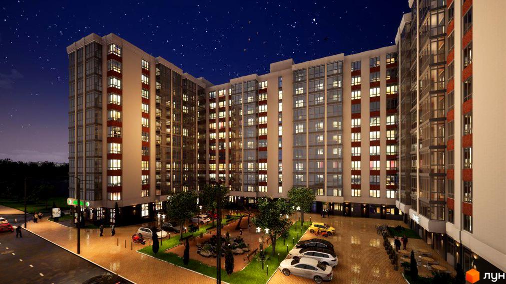 Житловий комплекс Акварель-4 вночі з підсвіченими вікнами та доглянутою прибудинковою територією з парковкою та зеленими зонами.