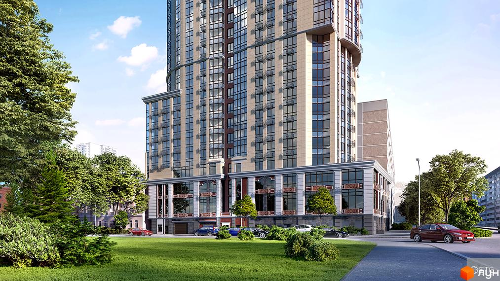 Житловий комплекс Володимирський. Висотна будівля з великою кількістю вікон, оздоблена світлим фасадом. На передньому плані зелена зона з деревами та припарковані автомобілі.