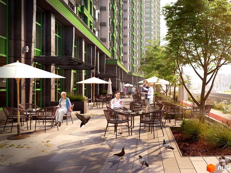 Житловий комплекс LIKO-GRAD Perfect Town з зеленою фасадною обробкою та просторою терасою з вуличними меблями та парасольками. На території комплексу розташовані дерева та місця для відпочинку.