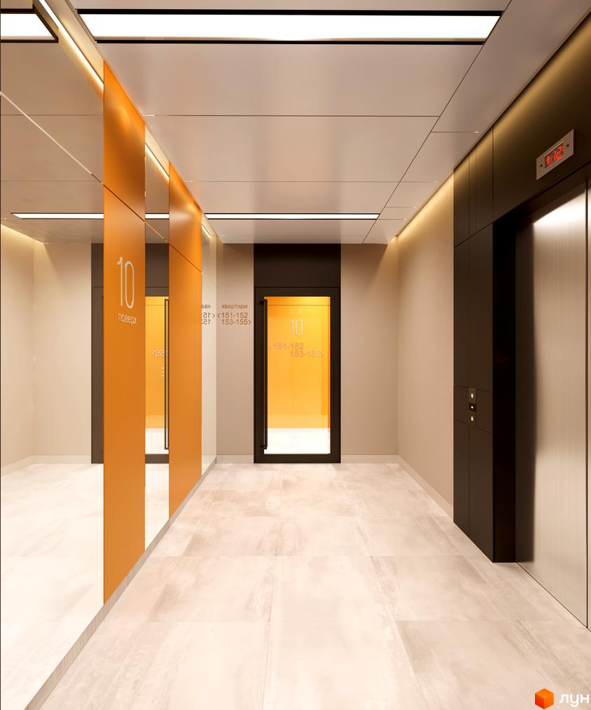 Вестибюль Житлового комплексу OK'LAND з світлою підлогою, помаранчевими навігаційними панелями та ліфтовим холом.