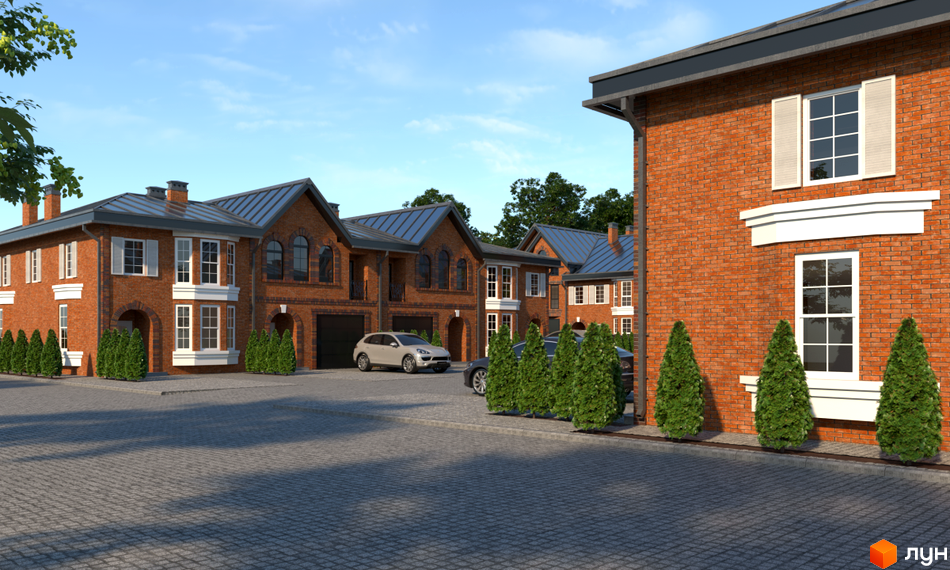 Цегляні будинки з білими вікнами та темним дахом. Перед будинками викладена бруківка, ростуть зелені кущі.