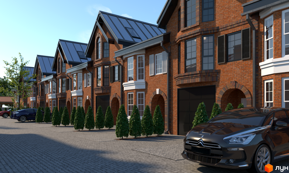 Цегляні таунхауси в П'ятихатках з темними дахами та гаражами. Перед будинками висаджені декоративні дерева, а територія вимощена бруківкою.