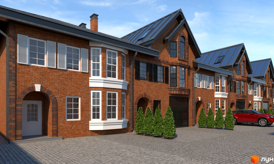 Цегляні таунхауси з мансардними дахами. На території перед будинками висаджені туї, а на стоянці стоїть червоний автомобіль.