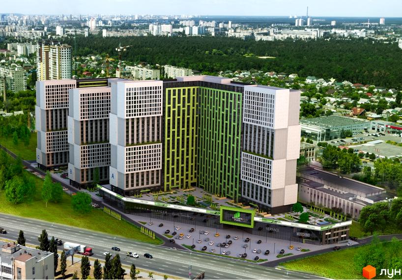 Житловий комплекс Olympic Park складається з багатосекційних будівель з сіро-бежевими та зеленими фасадами, що стоять над торговим центром з паркінгом.
