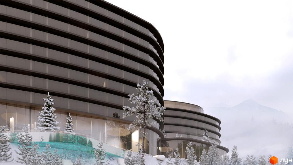 Житловий комплекс з панорамним склінням на тлі засніжених гір. На території комплексу ростуть ялинки, а також є басейн.