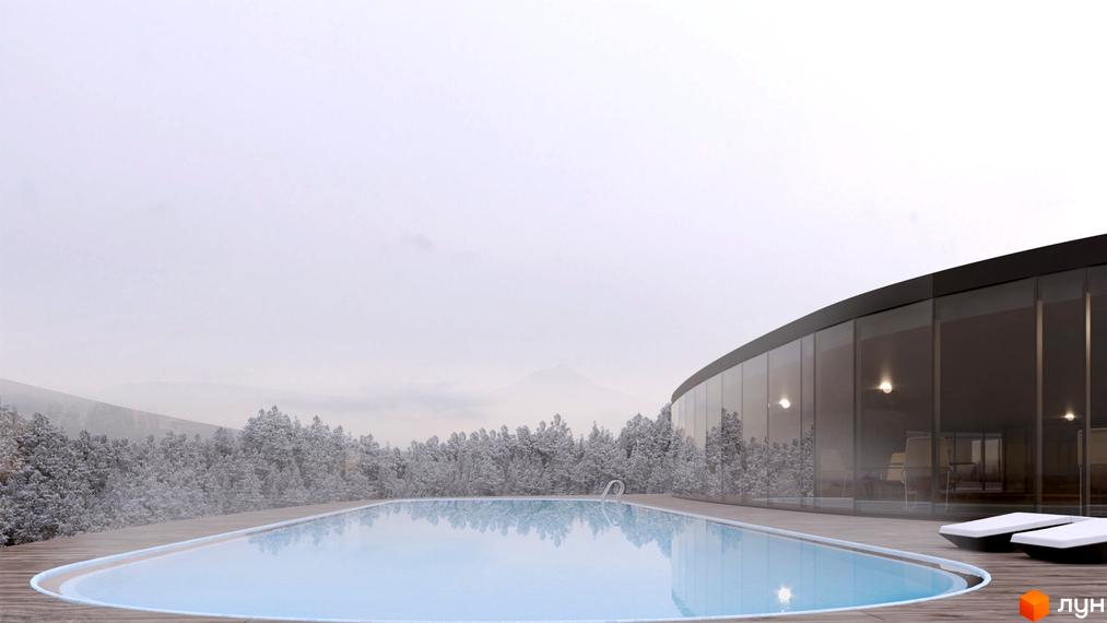 Басейн біля будівлі з панорамними вікнами. Поряд з басейном розташовані лежаки. Навколо будівлі засніжені дерева.