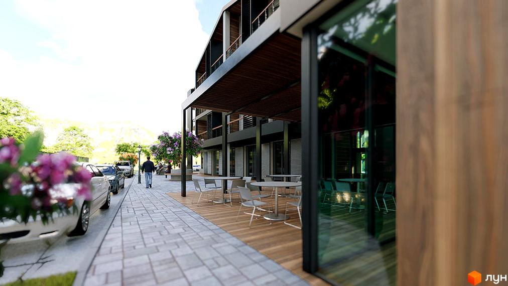 Зовнішній вигляд будівлі апарт-комплексу Shayan з терасою та столиками. Поряд з будинком тротуар та припарковані автомобілі.