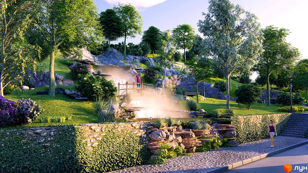 Зображення території біля ЖК Shayan. На фото видно ландшафтний дизайн з водоспадом, містком та зеленою зоною для відпочинку.