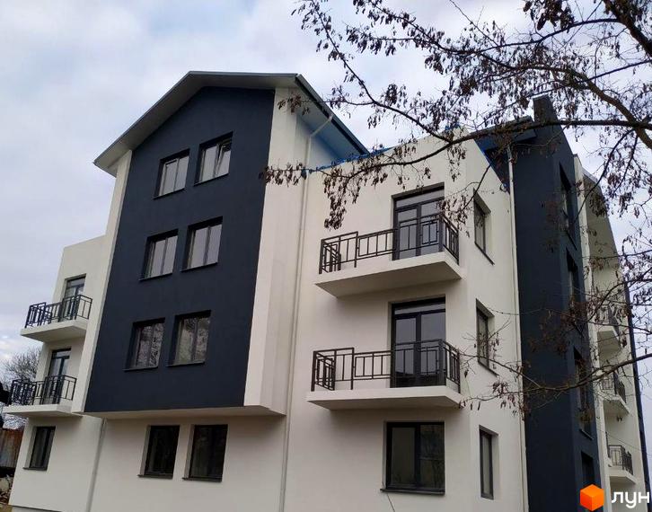 Зображення фасаду Житлового комплексу Панський острів з контрастними білими та темно-сірими елементами, балконами та вікнами.