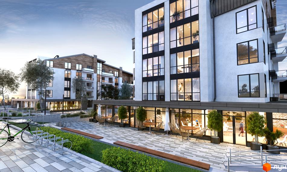 Новобудова ЖК Традиція з великою кількістю вікон та балконів, огородженою територією та велосипедною парковкою.