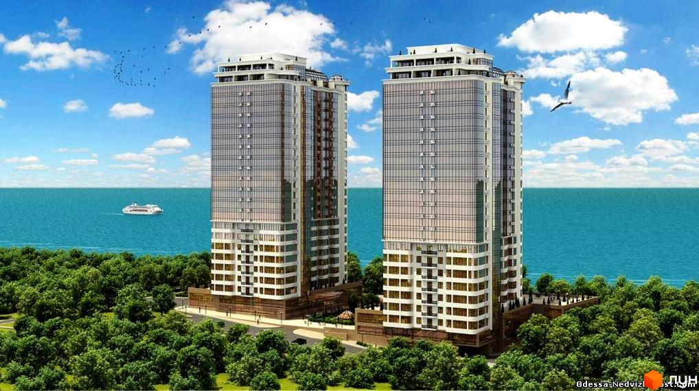 Житловий комплекс Гагарін Плаза 1 з двома висотними будинками, оточеними зеленими насадженнями та видом на море.