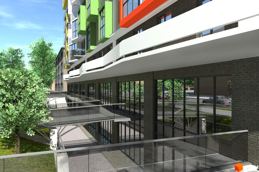 Зображення фасаду будинку Житлового комплексу Олександрівськ з великими вікнами та скляним переходом. Навколо зелені дерева.