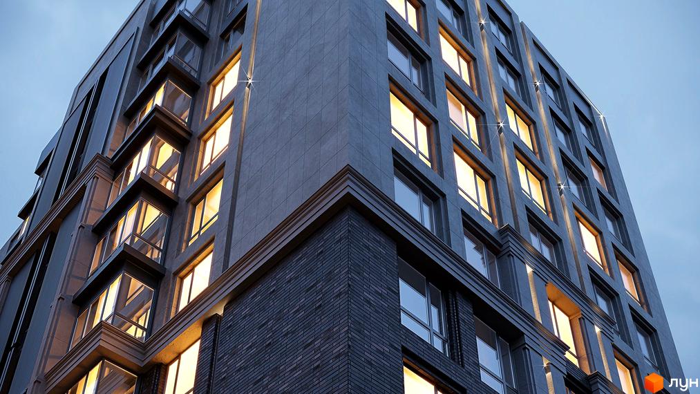 Зовнішній вигляд новобудови ЖК GENEVE з підсвіченими вікнами. Сучасна архітектура будівлі з темною цегляною облицовкою та великими вікнами.