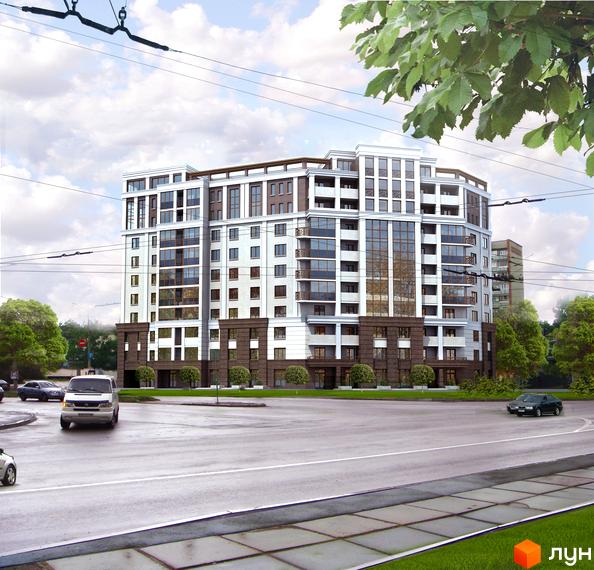 Житловий комплекс Шевченківський - це багатоповерхова новобудова з білою та коричневою обробкою фасаду, великими вікнами та балконами. Навколо комплексу розташовані зелені насадження та дорога з автомобілями.