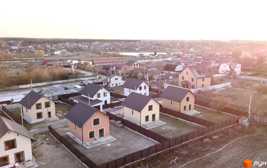 Котеджне містечко Green House: двоповерхові будинки зі світлими фасадами та темними дахами на приватних ділянках, огороджених парканом.