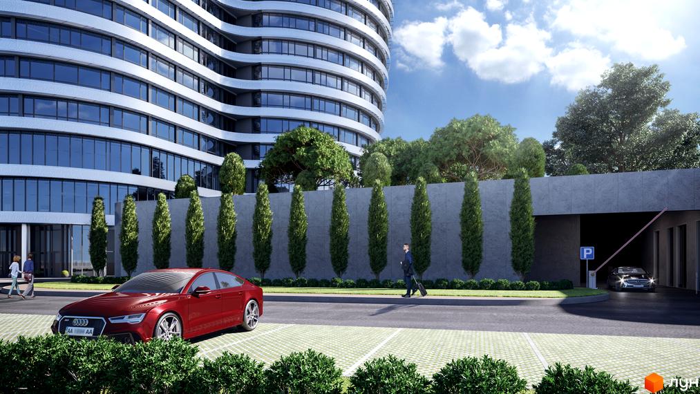 Житловий комплекс OASIS з вигнутим фасадом та скляними вікнами, перед ним доглянута прибудинкова територія з зеленими насадженнями та парковкою.