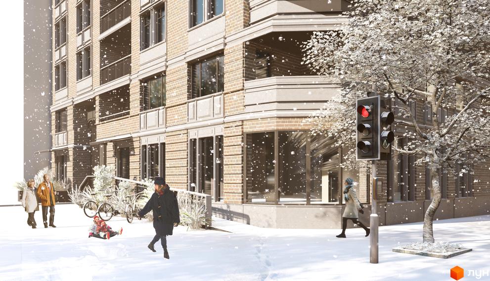 Житловий комплекс Пространство на Шмидта взимку. Будинок з цегляним фасадом та балконами, поруч дитяча гірка та дерева у снігу.