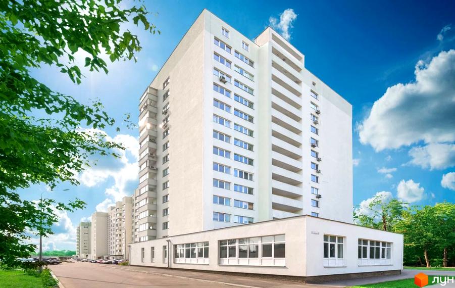 Житловий комплекс Поліський з сучасним фасадом та прибудинковою територією, облаштованою зеленими насадженнями.