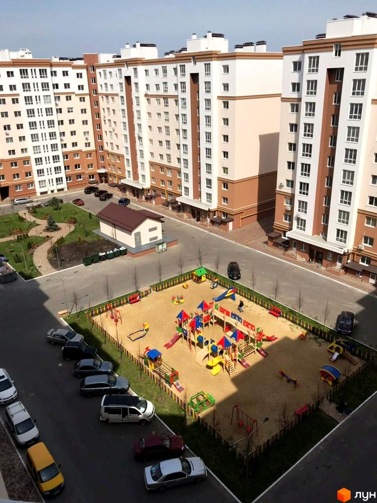 Житловий комплекс Львівський маєток з багатоповерховими будинками та дитячим майданчиком. На території комплексу розташовані зелені зони та паркувальні місця.