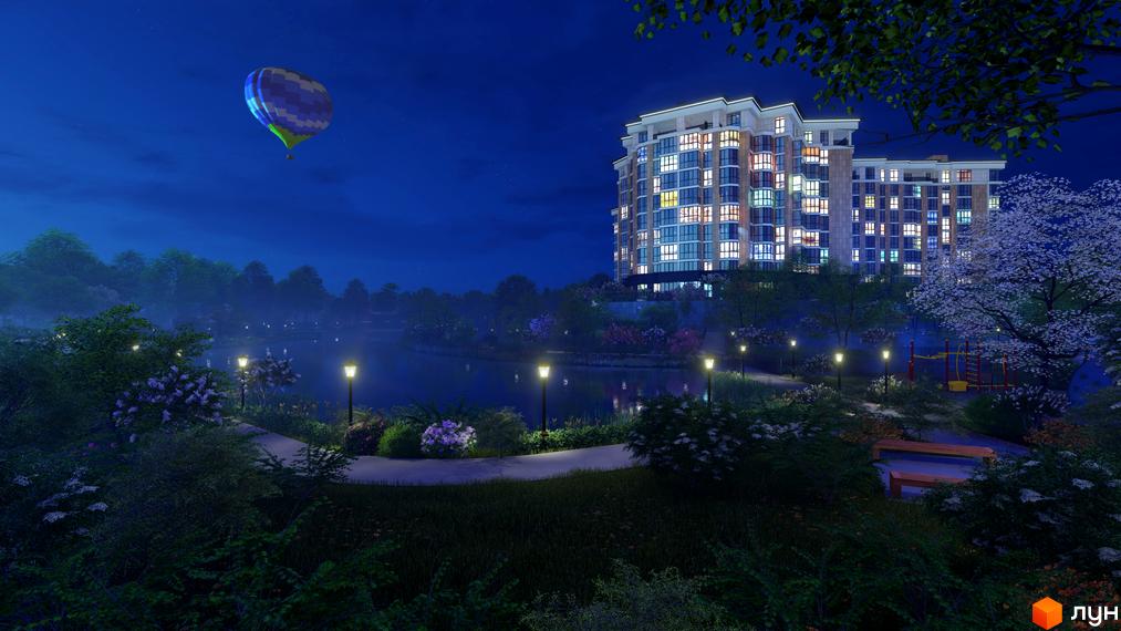 Зображення Житлового комплексу Оселя Парк вночі. Вигляд багатоповерхового будинку біля озера з освітленою прибудинковою територією.