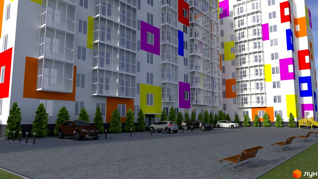 Житловий комплекс Воробйові гори Family з кольоровими вставками на фасаді. На подвір'ї припарковані автомобілі та встановлені лавки.