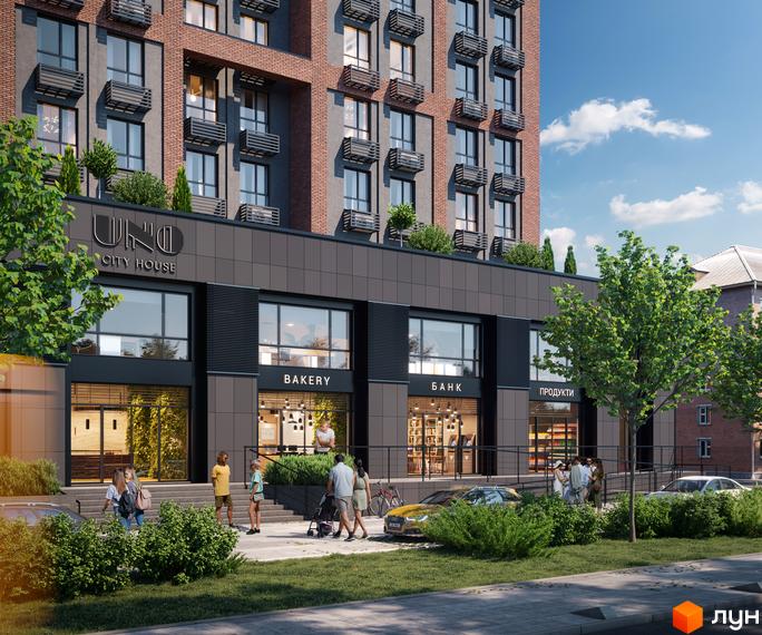 Новобудова UNO City House з фасадом з цегли та сірих панелей. Біля будинку розташовані магазини, дерева та зона відпочинку.