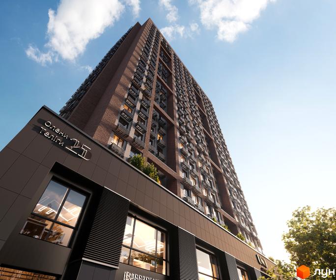 Житловий комплекс UNO City House з цегляним фасадом та великими вікнами. Сучасна архітектура висотної будівлі на фоні блакитного неба з хмарами.