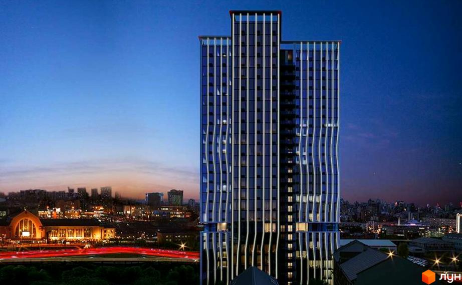 Апарт-комплекс Times - висотна будівля з хвилястим фасадом та підсвіткою на фоні вечірнього міста. Огляньте сучасну архітектуру та комфортне життя.