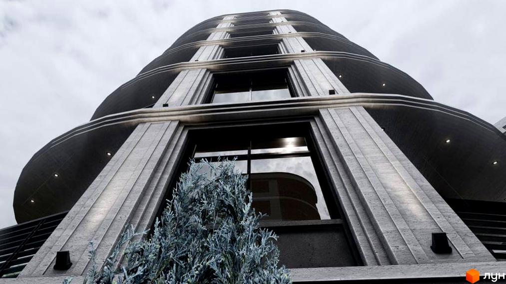 Фасад Житлового комплексу Лідерсівський з вигнутими балконами та великими вікнами, перед будинком зелені насадження.