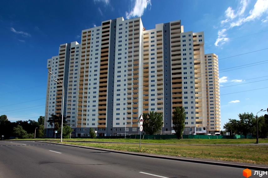 Житловий комплекс Перовський з висотними будинками та прибудинковою територією. На передньому плані зелена зона та дорога.