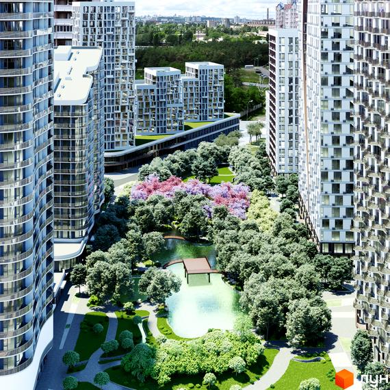 Високі будівлі житлового комплексу Creator City з вигнутими фасадами. Навколо облаштований парк з озером та зеленими зонами.