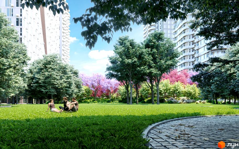 Житловий комплекс Creator City з парком та відпочиваючими на газоні. Сучасні будівлі оточені зеленню та квітучими деревами.