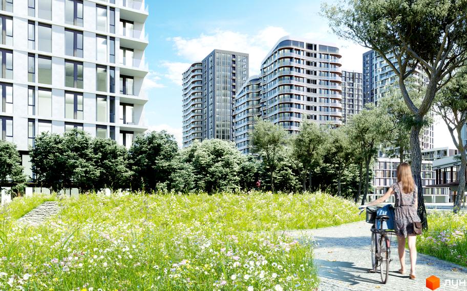 Житловий комплекс Creator City з багатоповерховими будинками та зеленою зоною з квітами. На території комплексу є доріжка та людина з велосипедом.