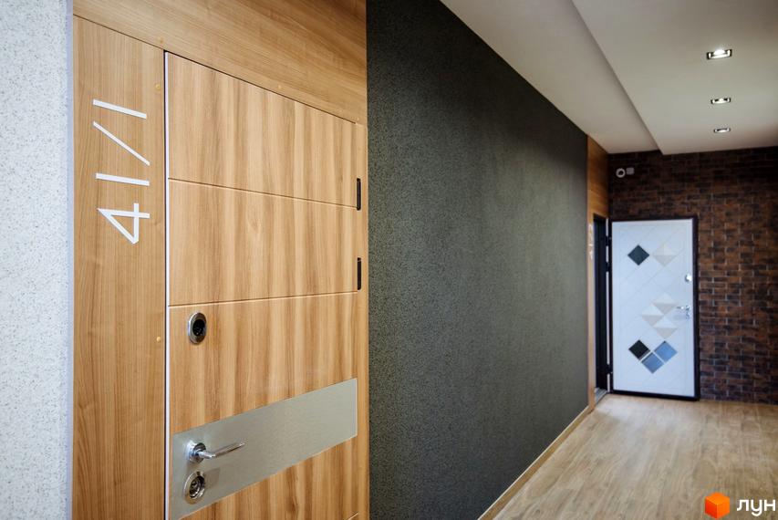 Клубний будинок Craft: двері з дерев'яною обробкою та номер 41/1, коридор з цегляною стіною та дверима.