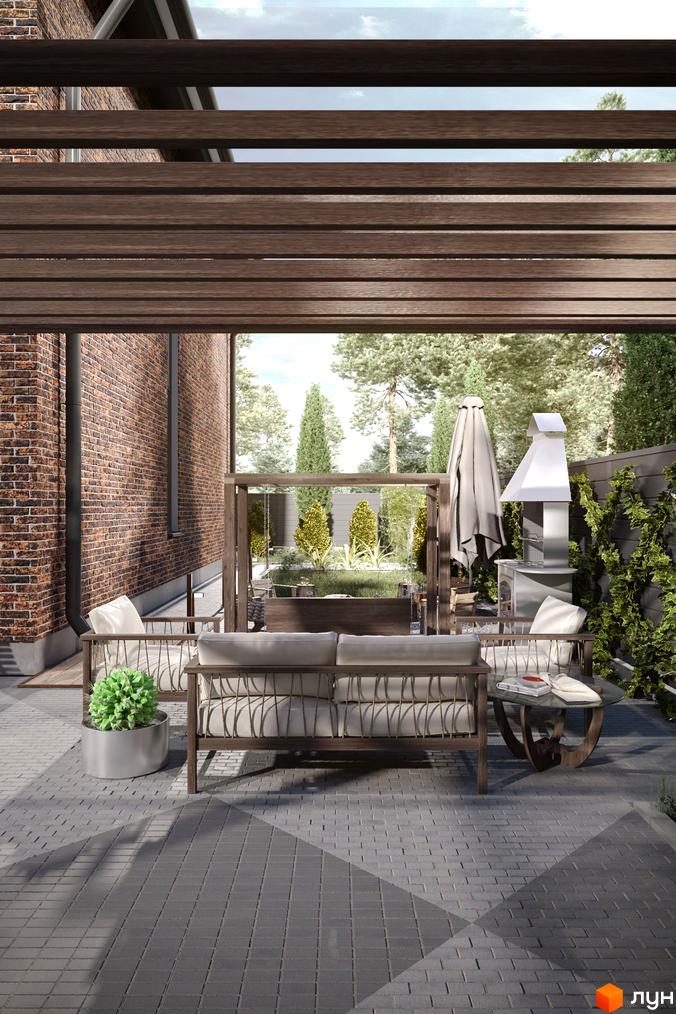 Зовнішній вигляд Nekrasov Townhouse 2 з цегляною стіною та зоною відпочинку з диваном і кріслами під дерев'яною перголою.