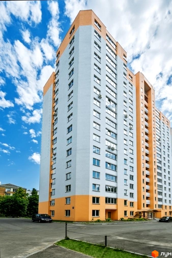 Житловий комплекс на вул. Кирила Розумовського, 19, з сучасним фасадом та прибудинковою територією, облаштованою для комфортного відпочинку.