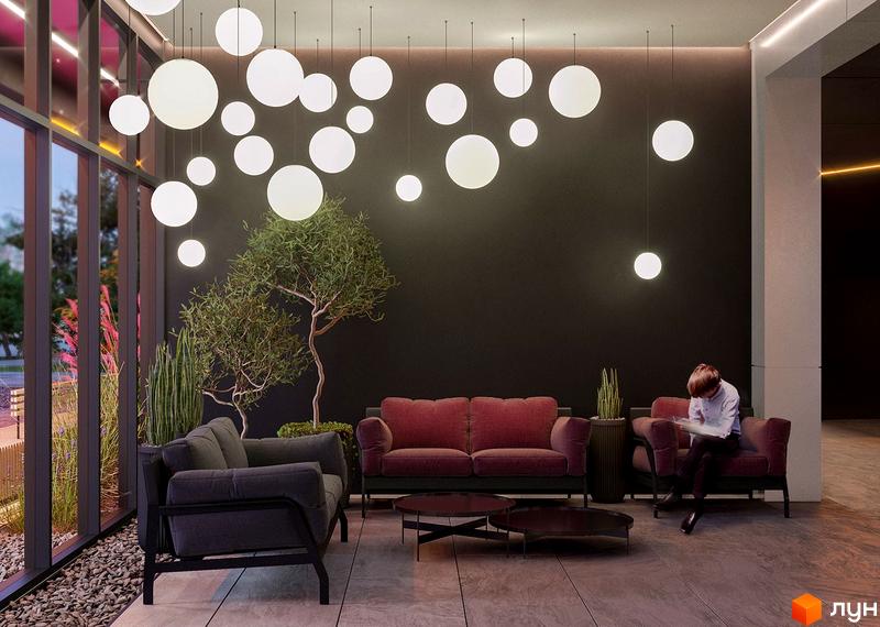 Інтер'єр холу житлового комплексу Great з диванами, деревом та підвісними світильниками. Сучасний дизайн зони відпочинку.