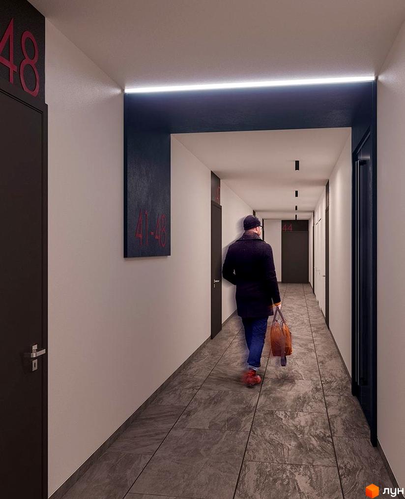 Комплекс Great, сучасний коридор з номерами квартир та освітленням. Людина з сумкою йде коридором.
