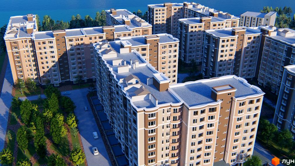 Житловий комплекс Дім у моря з висотними будівлями бежевих та коричневих відтінків, розташований біля моря серед зелених насаджень та доріг.