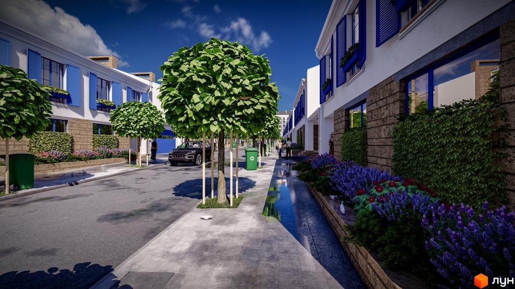 Зображення таунхаусів Club City з синіми вікнами та зеленими насадженнями вздовж вулиці. На передньому плані дерева та тротуар.